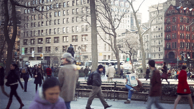 a-man-quietly-reads-a-newspaper-amidst-the-hustle-and-bustle-of-new-york-city-in-this-animated-gif-by-cinemagraphs